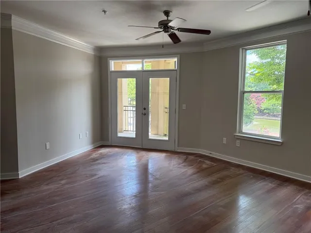 an empty room with windows and closet