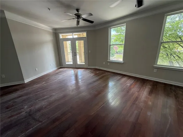 a view of empty room with wooden floor