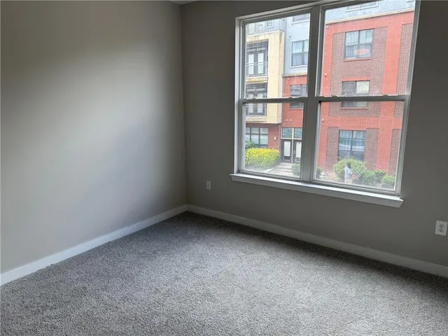 an empty room with chandelier fan