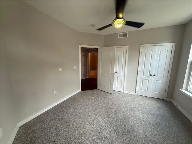 a view of a hallway with wooden floor and entryway