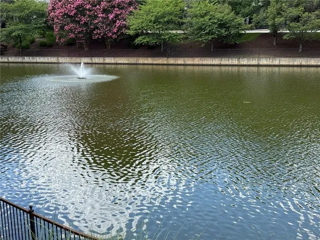 a view of a patio with couches and table and chairs and potted plants