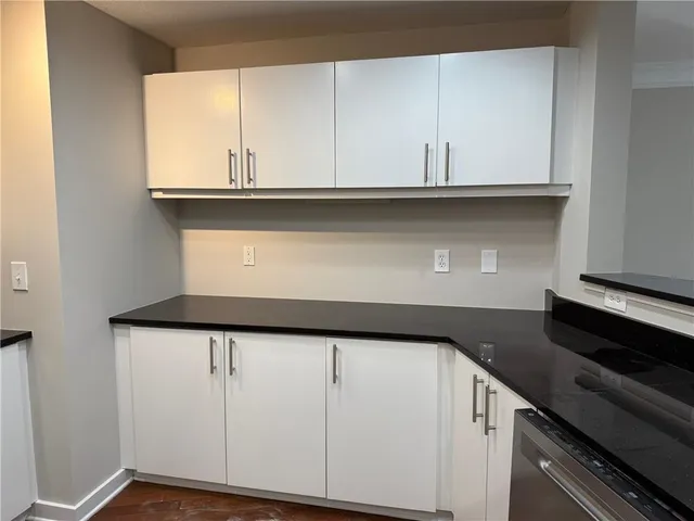 a kitchen with granite countertop a sink and a window