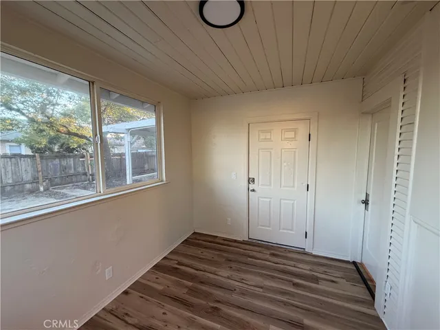 a view of a room with wooden floor and window