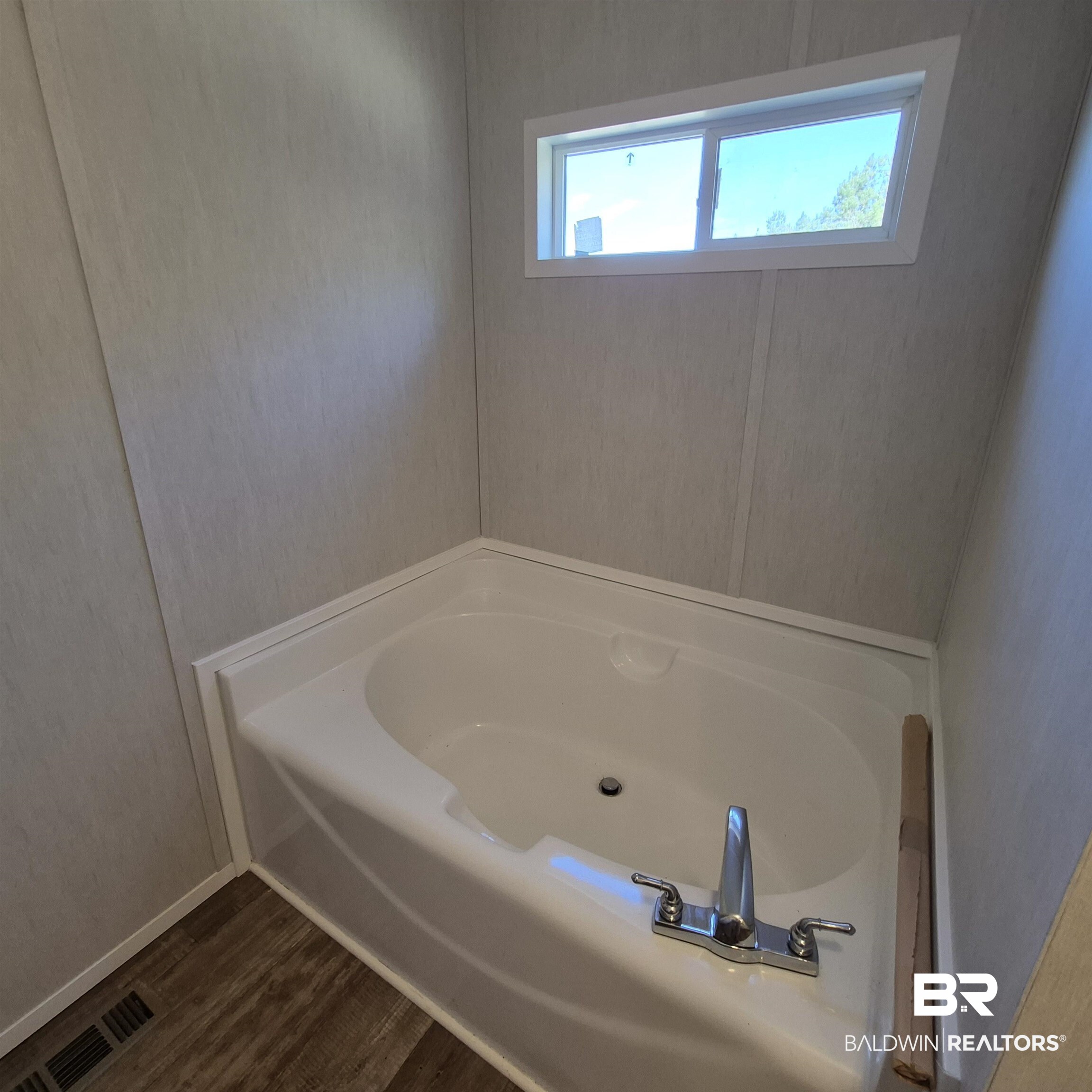8867 Old Stage Road Repton, AL 36475 - Photo 20 of 37 Bathroom with a bath and dark wood-style floors