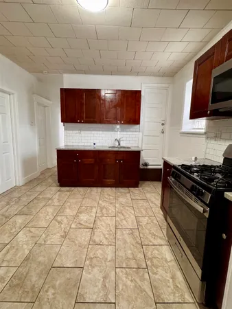 a view of kitchen with a sink and a stove top oven