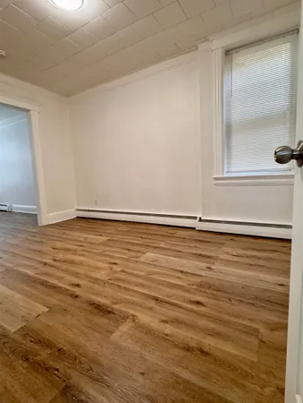 a view of an empty room and wooden floor