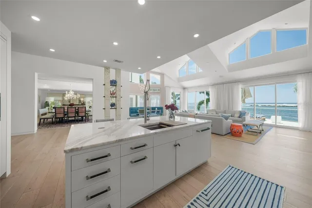 a dining room with furniture wooden floor a rug and a painting