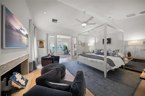 a bedroom with a bed and a lamp on the dresser