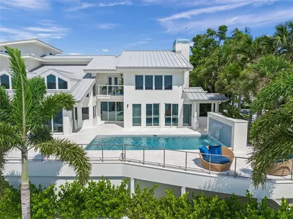a living room with fireplace furniture and a large window