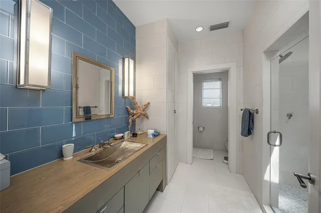 a bedroom with a bed couch and window