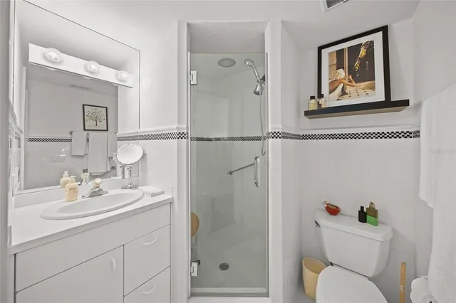 a view of a backyard with chair and potted plants