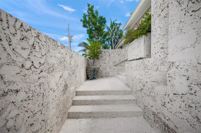 a large kitchen with kitchen island a stove a sink a refrigerator and white cabinets with wooden floor