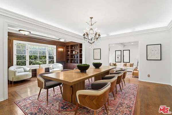 a dining room with furniture a rug and a chandelier