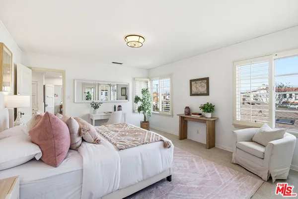 a bedroom with a large bed and a couch