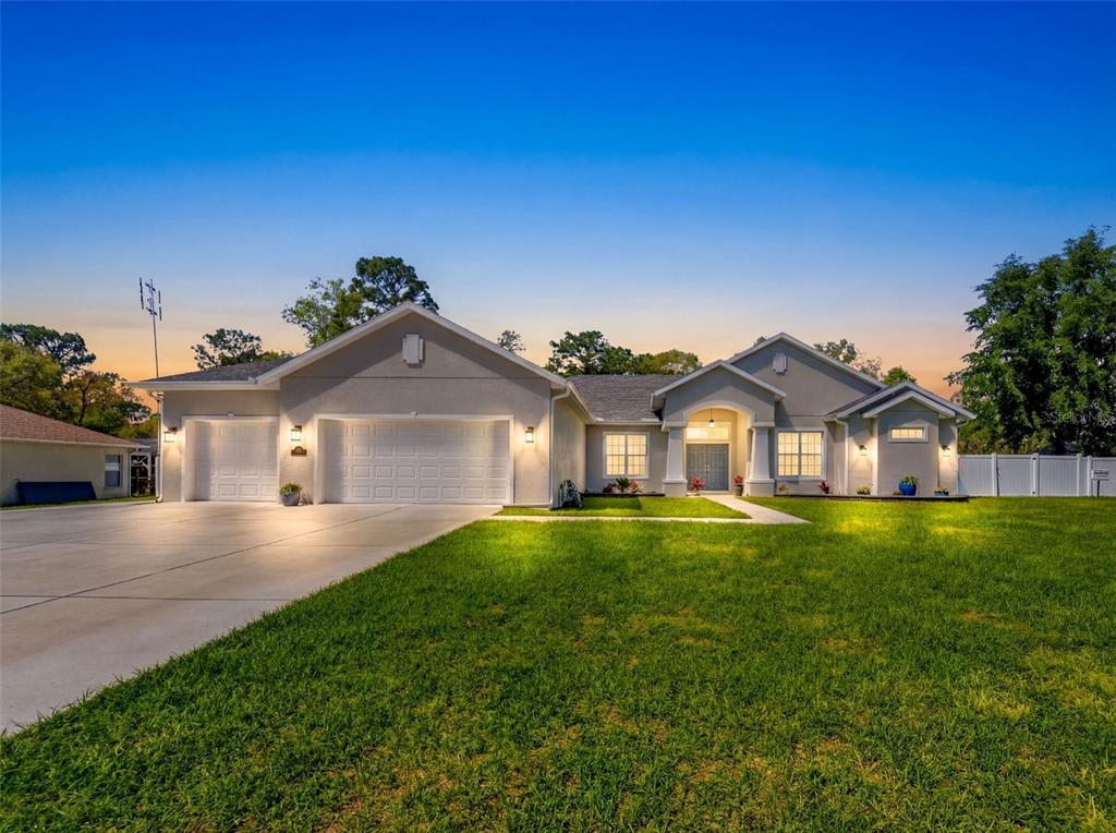 a front view of a house with a yard and garage