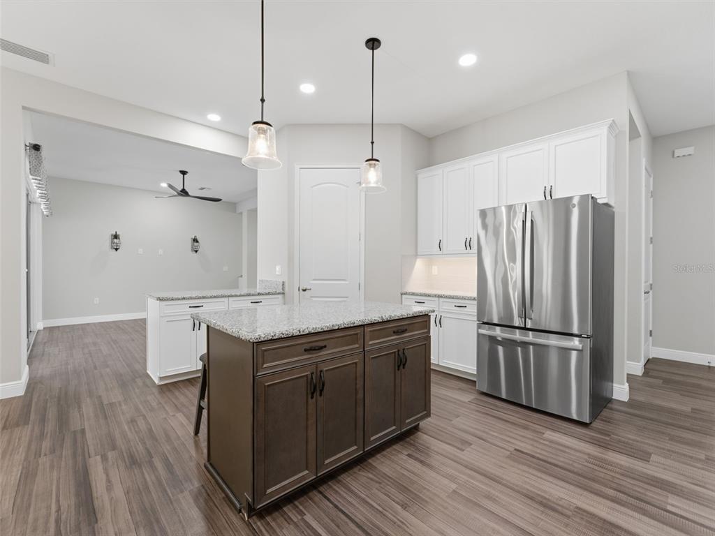 4025 Spring Park Way Brooksville, FL 34604 - Photo 15 of 97 a kitchen with a refrigerator sink and wooden cabinets