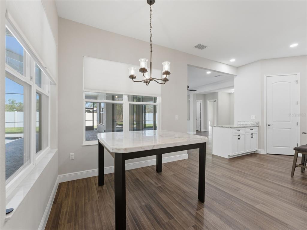 4025 Spring Park Way Brooksville, FL 34604 - Photo 21 of 97 a view of a room with wooden floor and windows