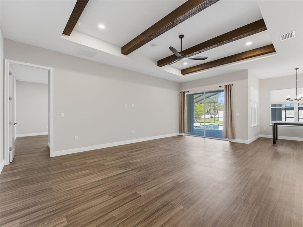 4025 Spring Park Way Brooksville, FL 34604 - Photo 26 of 97 a view of an empty room with wooden floor and a window
