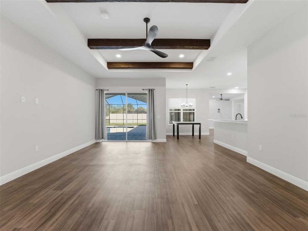 4025 Spring Park Way Brooksville, FL 34604 - Photo 27 of 97 a view of an empty room with wooden floor and a window