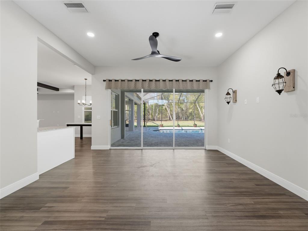 4025 Spring Park Way Brooksville, FL 34604 - Photo 30 of 97 a view of an empty room with wooden floor and a window