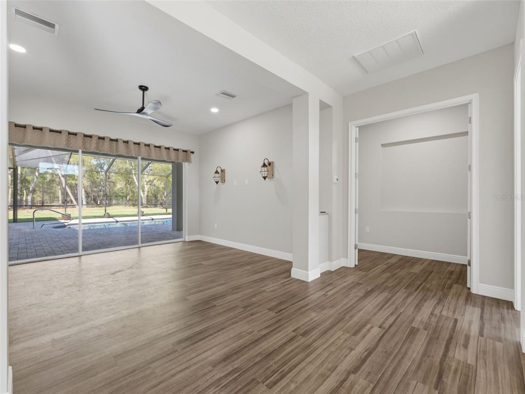 4025 Spring Park Way Brooksville, FL 34604 - Photo 33 of 97 an empty room with wooden floor and windows