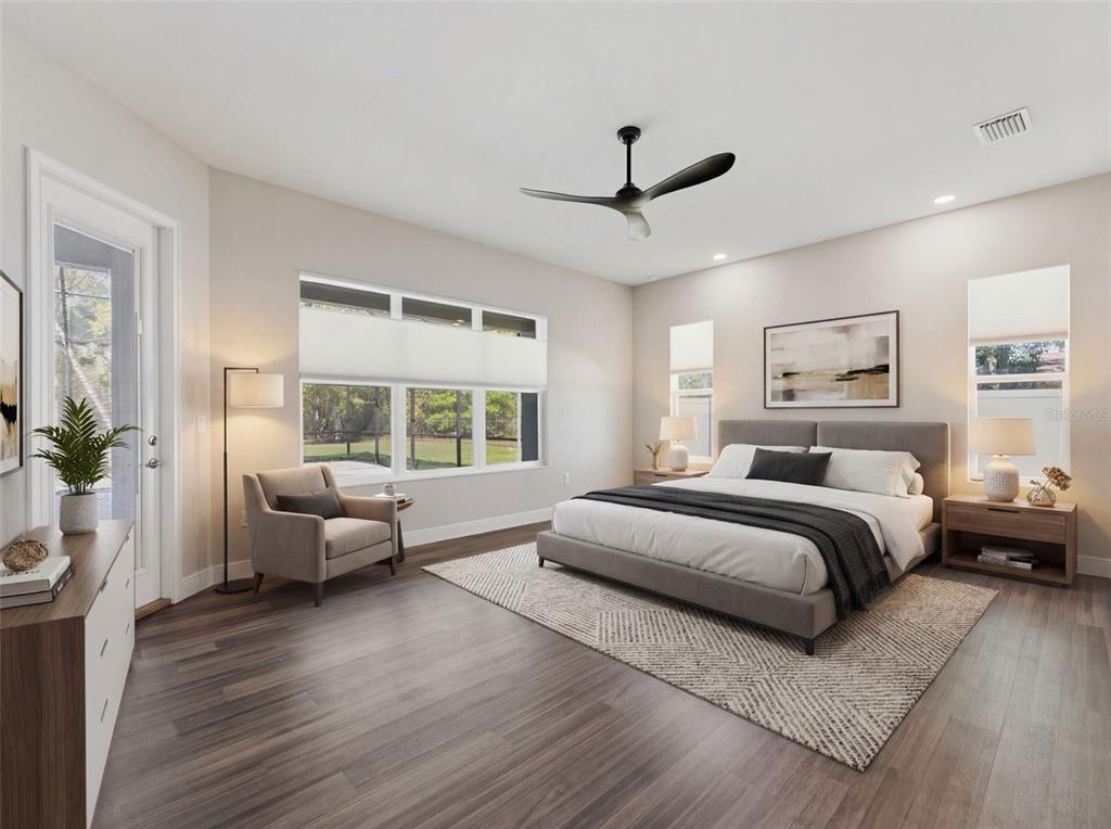 4025 Spring Park Way Brooksville, FL 34604 - Photo 34 of 97 a spacious bedroom with a bed and a couch