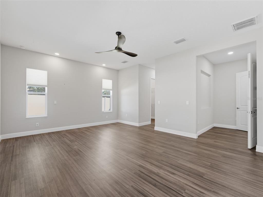 4025 Spring Park Way Brooksville, FL 34604 - Photo 35 of 97 a view of an empty room with wooden floor and a window