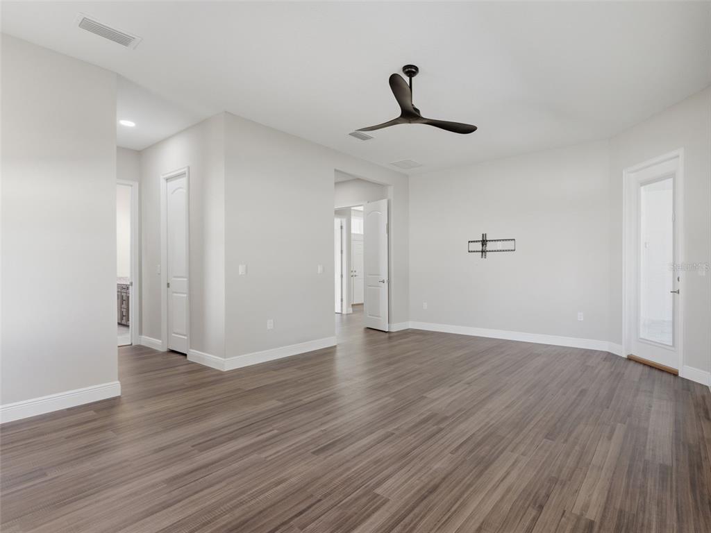 4025 Spring Park Way Brooksville, FL 34604 - Photo 36 of 97 a view of an empty room with wooden floor