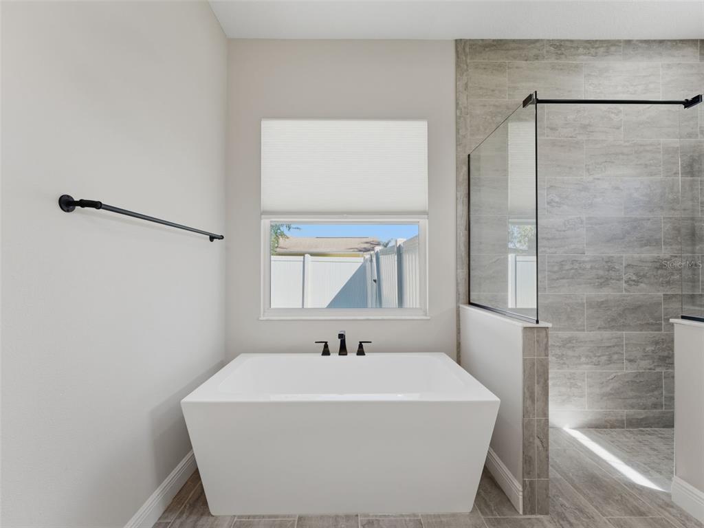 4025 Spring Park Way Brooksville, FL 34604 - Photo 41 of 97 a white bath tub sitting next to a white sink