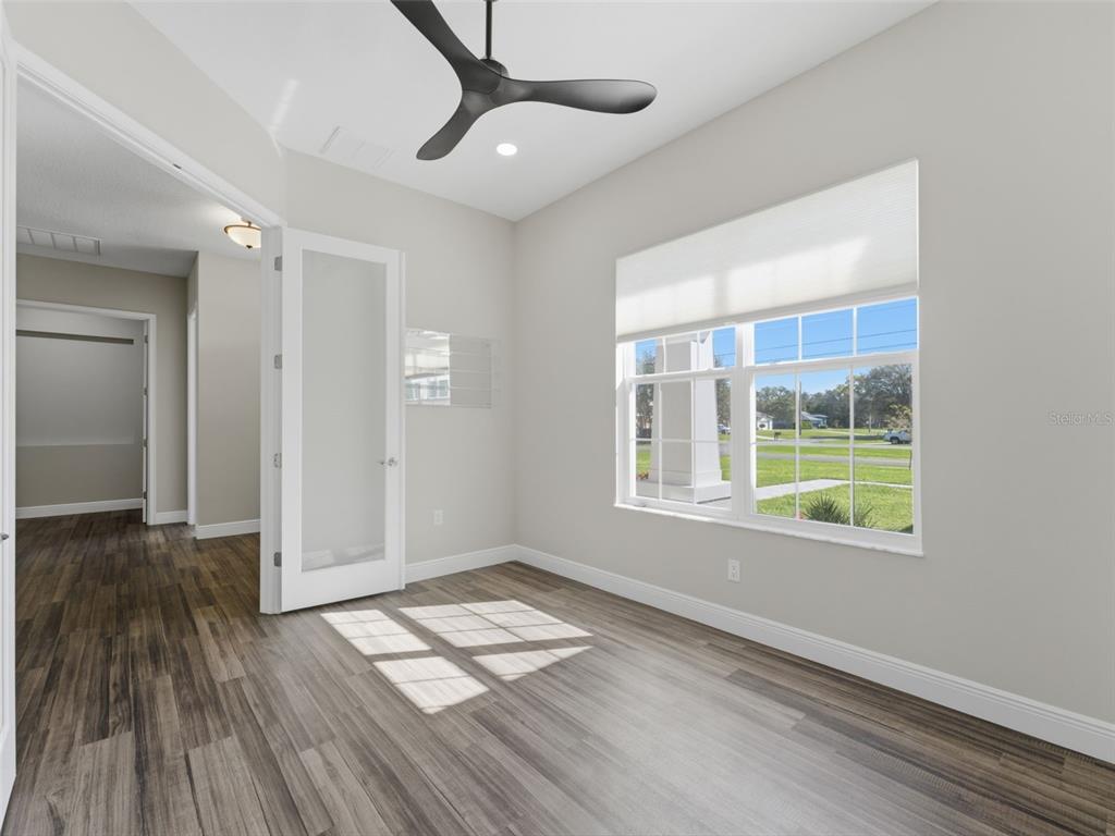 4025 Spring Park Way Brooksville, FL 34604 - Photo 47 of 97 a view of empty room with wooden floor and fan