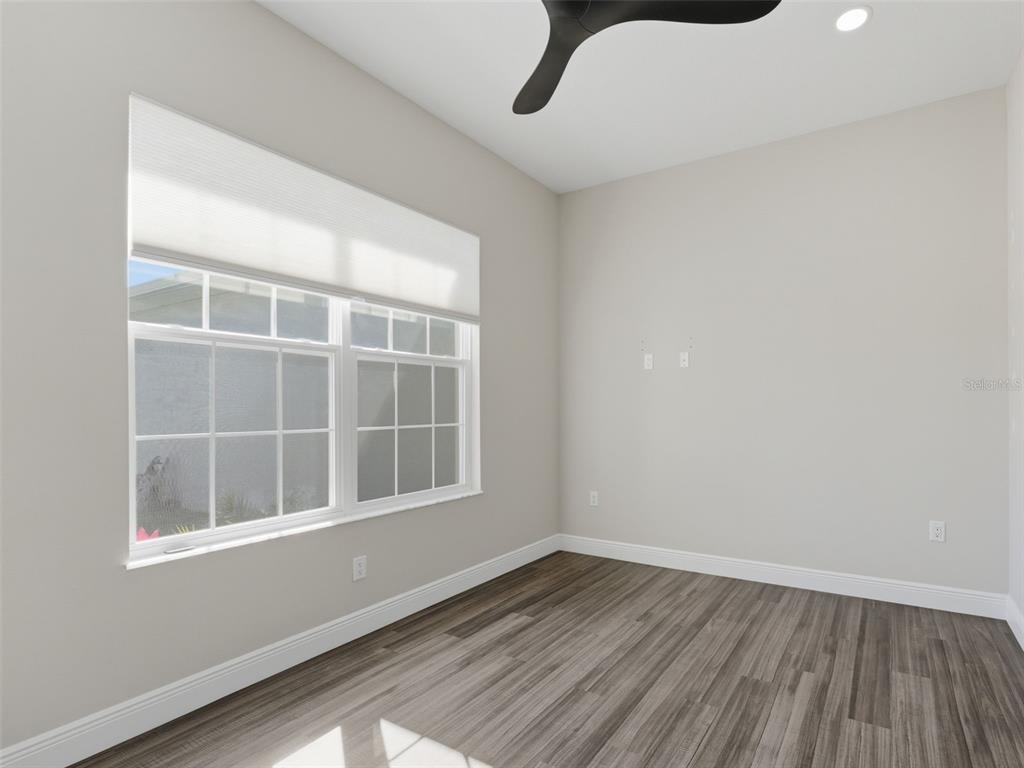 4025 Spring Park Way Brooksville, FL 34604 - Photo 49 of 97 a view of an empty room with wooden floor and a window