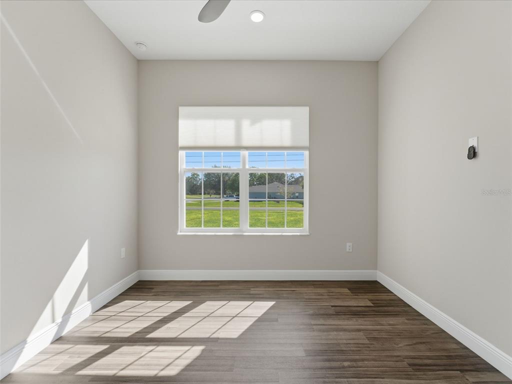 4025 Spring Park Way Brooksville, FL 34604 - Photo 54 of 97 a view of an empty room with wooden floor and a window