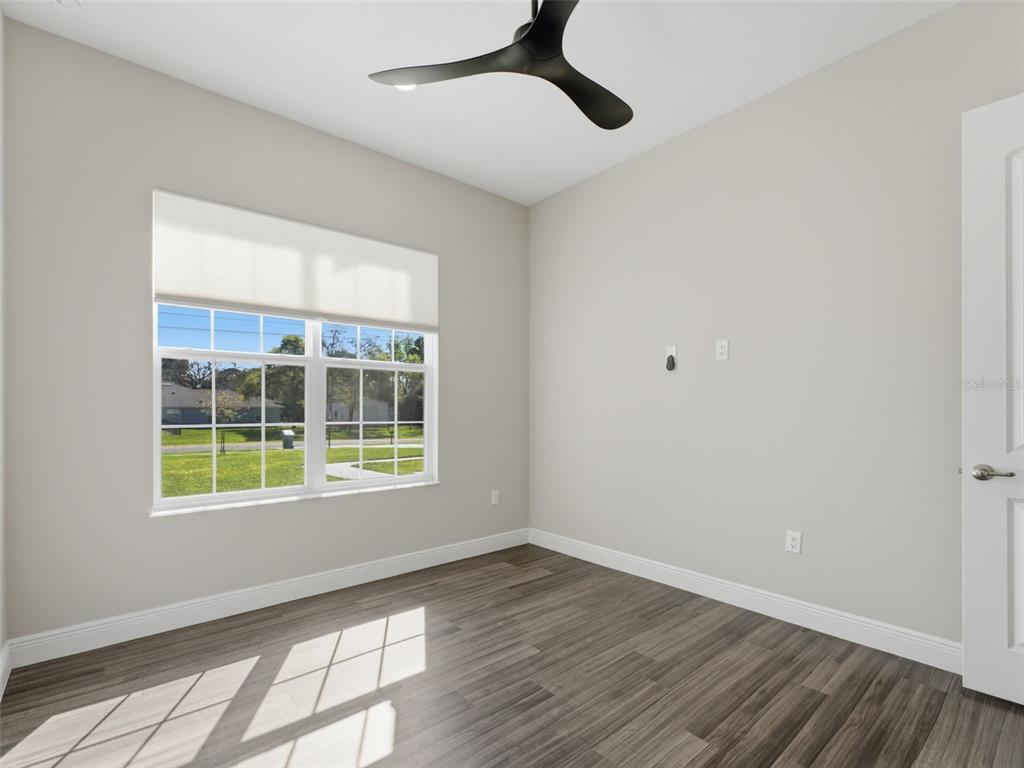 4025 Spring Park Way Brooksville, FL 34604 - Photo 55 of 97 a view of an empty room with wooden floor and a window