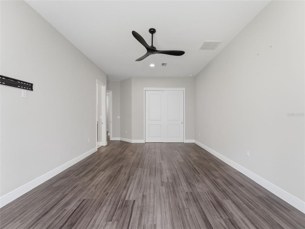 4025 Spring Park Way Brooksville, FL 34604 - Photo 57 of 97 wooden floor in an empty room
