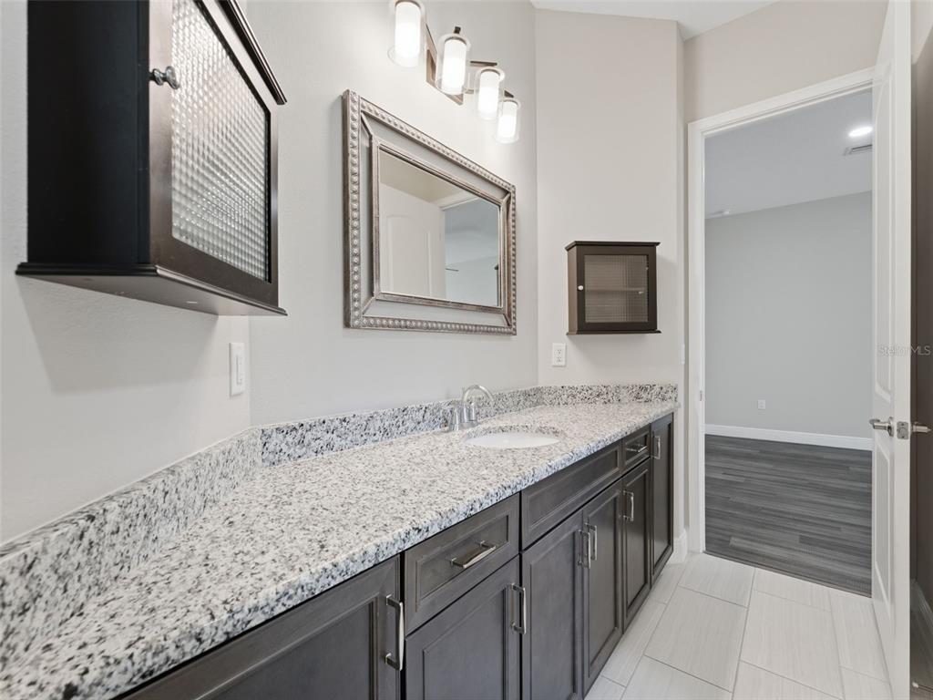4025 Spring Park Way Brooksville, FL 34604 - Photo 59 of 97 a bathroom with a sink and a mirror