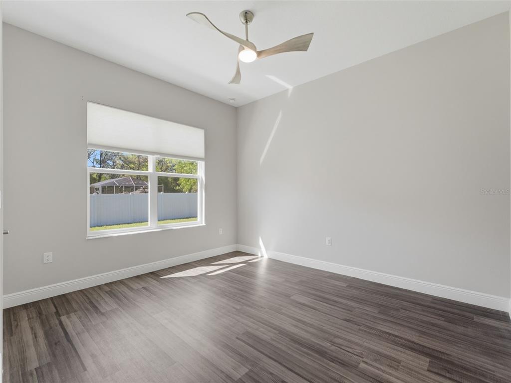 4025 Spring Park Way Brooksville, FL 34604 - Photo 62 of 97 an empty room with wooden floor and windows