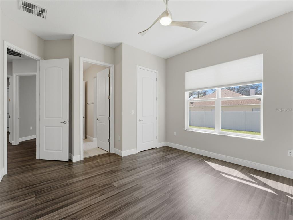 4025 Spring Park Way Brooksville, FL 34604 - Photo 63 of 97 an empty room with wooden floor and windows