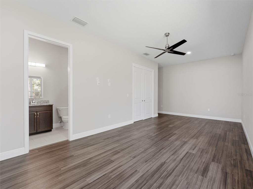4025 Spring Park Way Brooksville, FL 34604 - Photo 67 of 97 a view of empty room with wooden floor