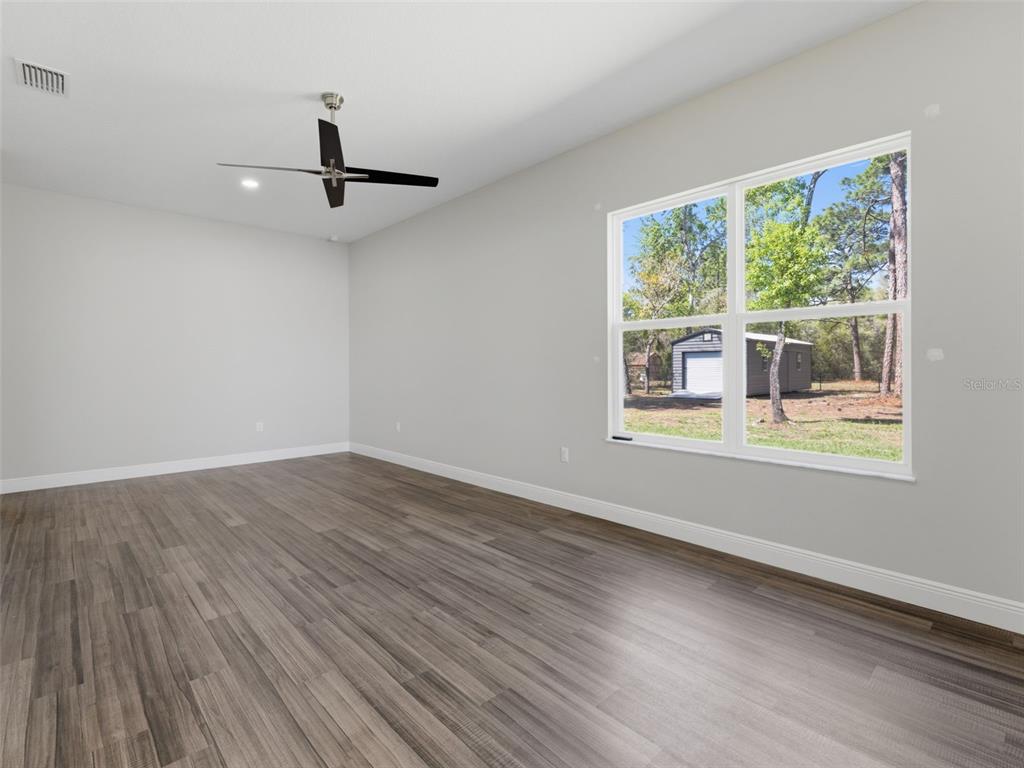 4025 Spring Park Way Brooksville, FL 34604 - Photo 68 of 97 a view of an empty room with wooden floor and a window
