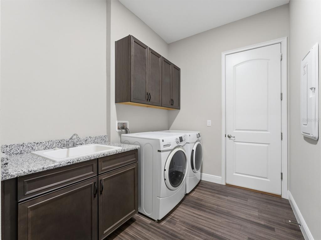 4025 Spring Park Way Brooksville, FL 34604 - Photo 71 of 97 a utility room with sink dryer and washer