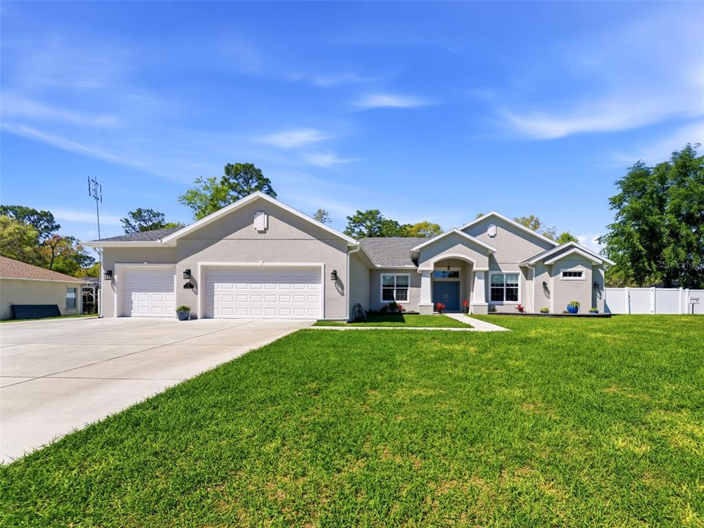 4025 Spring Park Way Brooksville, FL 34604 - Photo 8 of 97 a front view of a house with a yard and garage