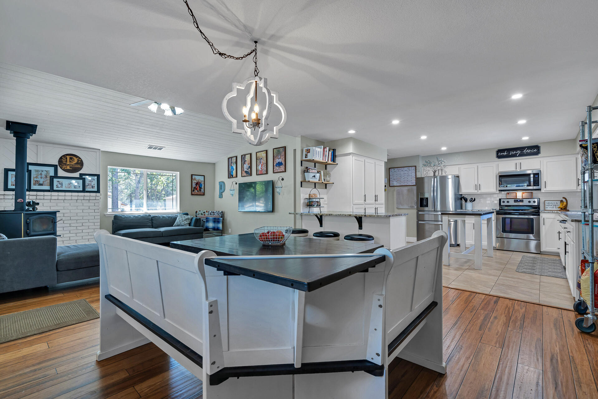 23570 Cassel Fall River Road Fall River Mills, CA 96028 - Photo 15 of 73 a kitchen with stainless steel appliances granite countertop a sink stove and wooden floor