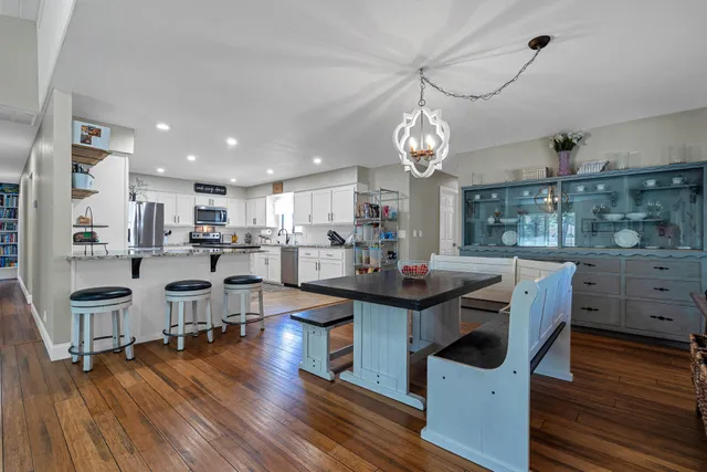 a kitchen with stainless steel appliances granite countertop a sink refrigerator and cabinets