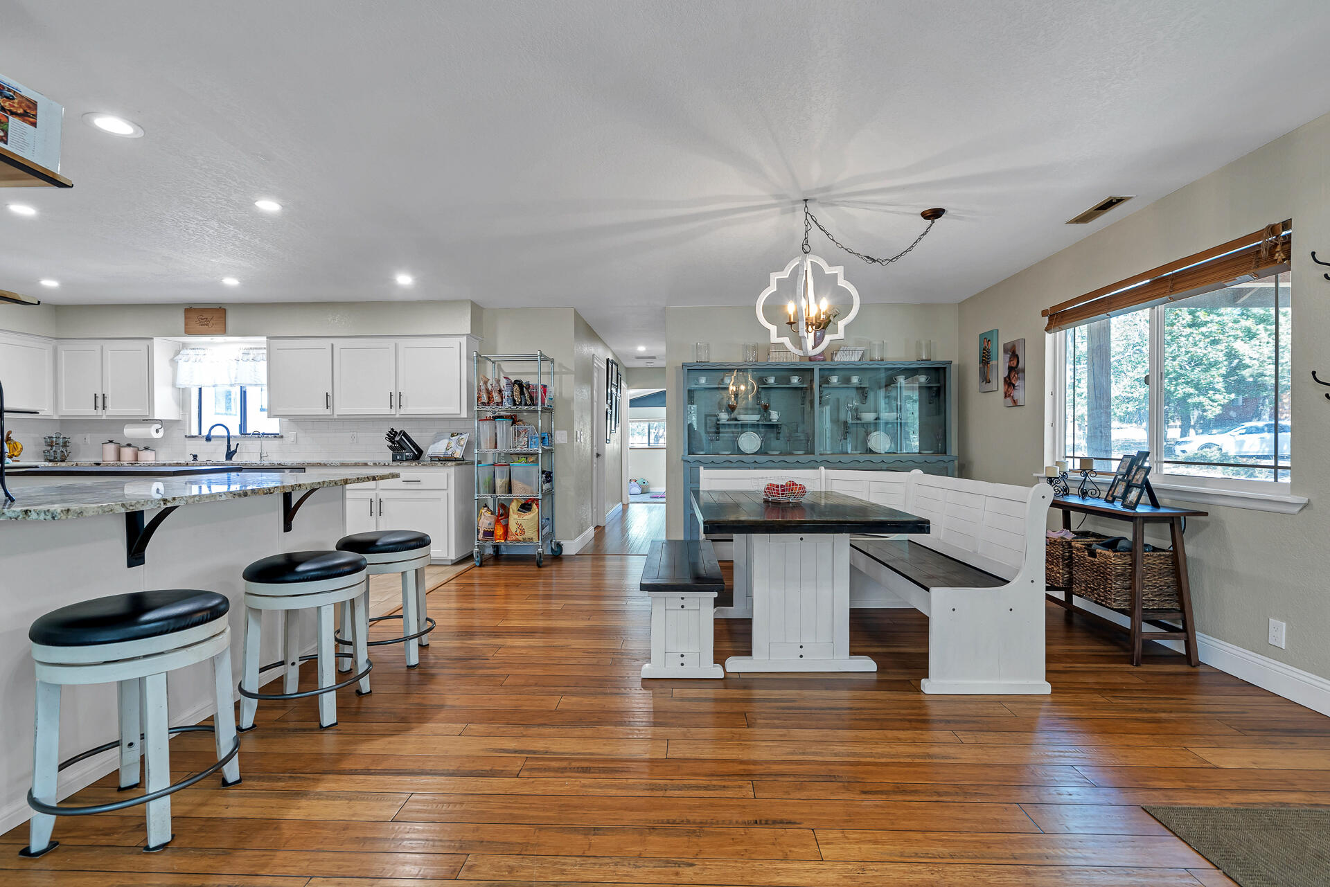 23570 Cassel Fall River Road Fall River Mills, CA 96028 - Photo 17 of 73 a open kitchen with stainless steel appliances granite countertop a stove top oven a refrigerator a dining table and chairs with wooden floor