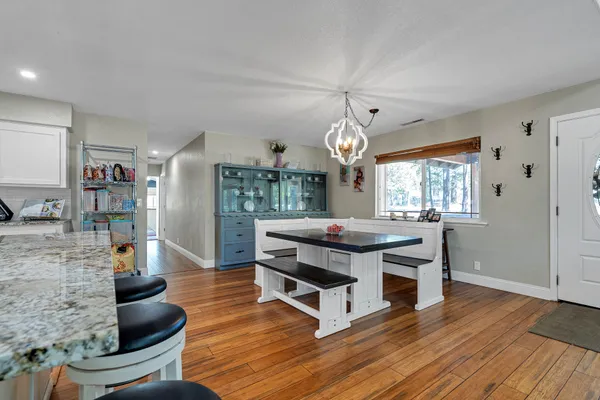 a kitchen with stainless steel appliances granite countertop a sink refrigerator and cabinets