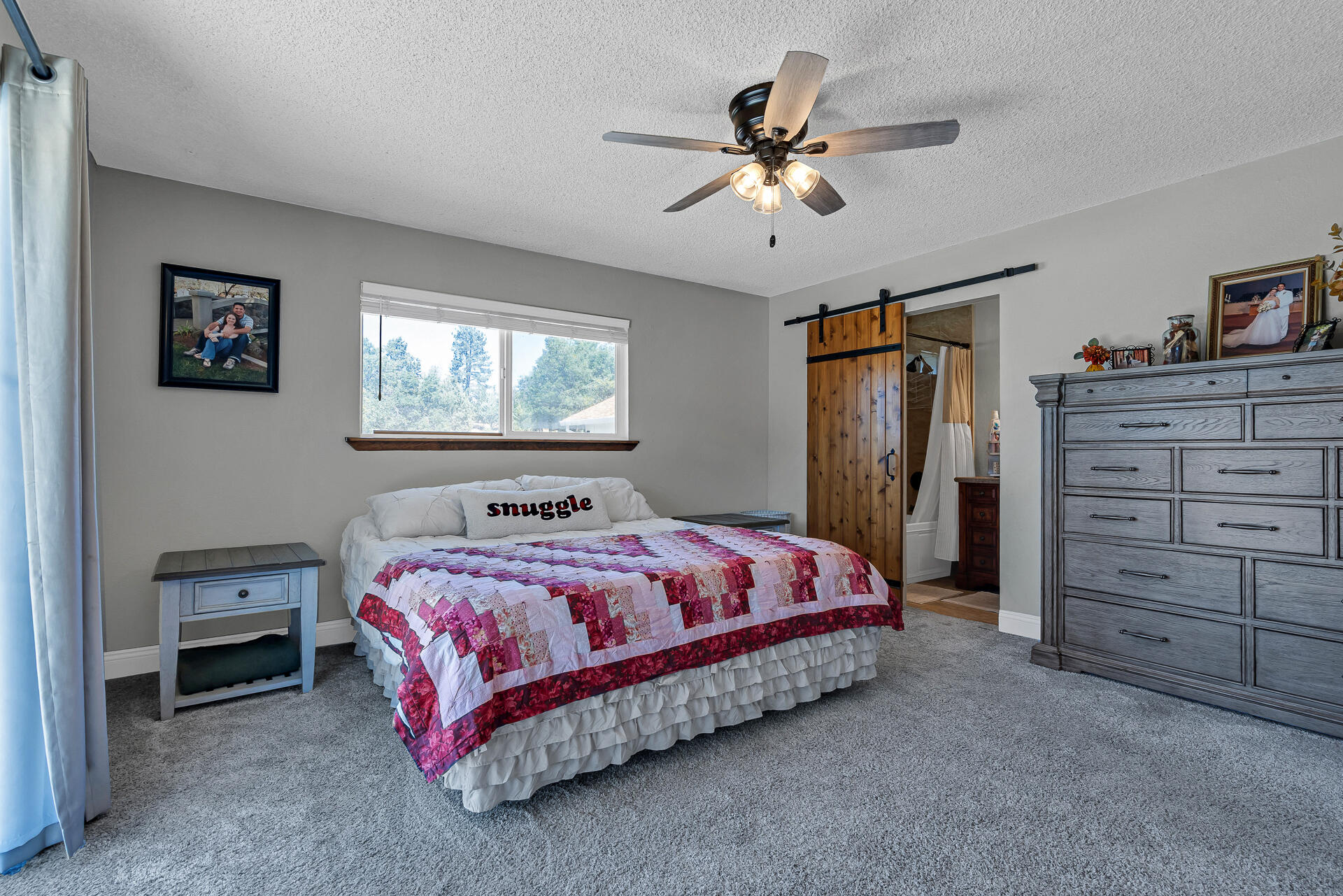 23570 Cassel Fall River Road Fall River Mills, CA 96028 - Photo 30 of 73 a bedroom with a bed and a chandelier