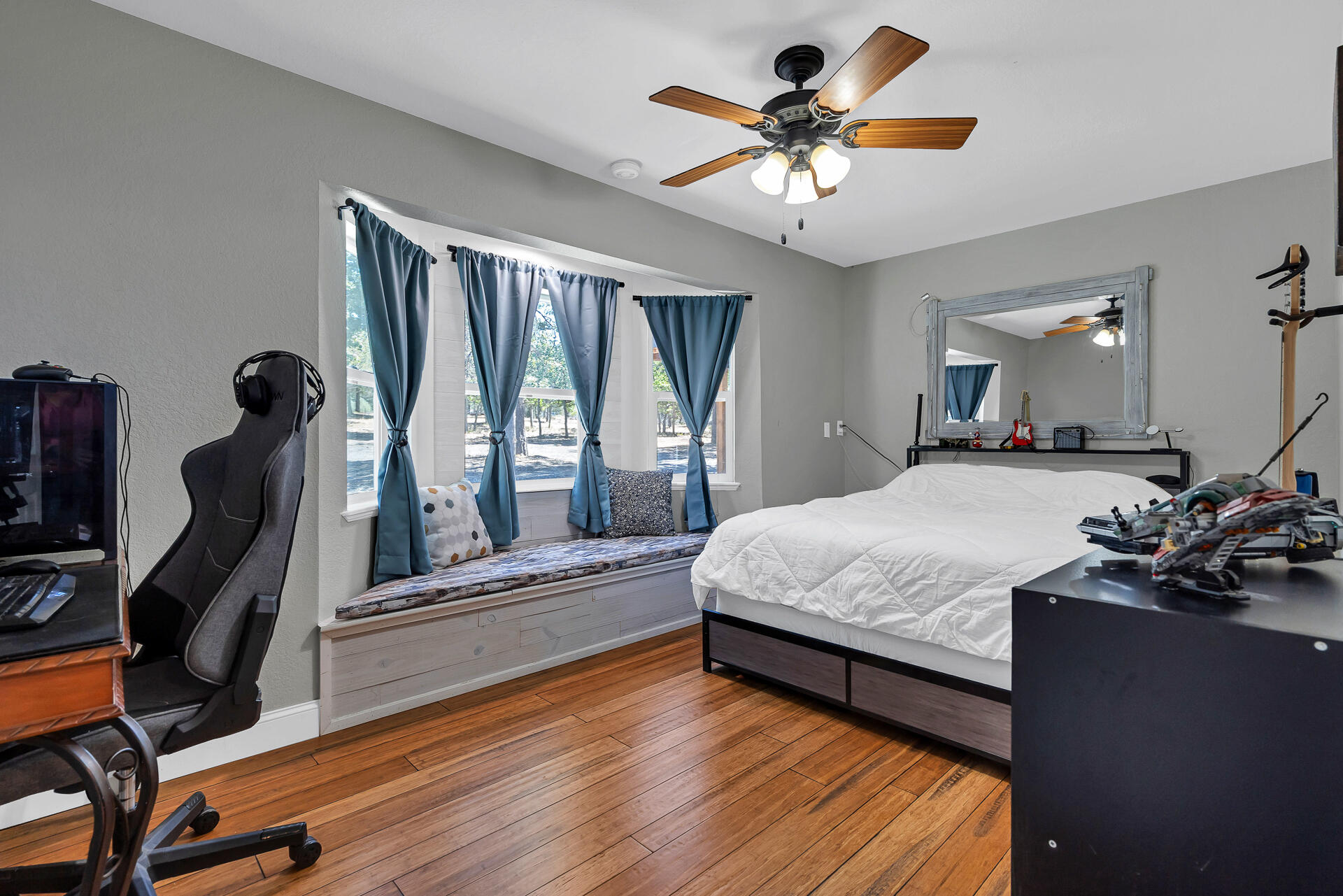 23570 Cassel Fall River Road Fall River Mills, CA 96028 - Photo 33 of 73 a spacious bedroom with a bed and a chandelier