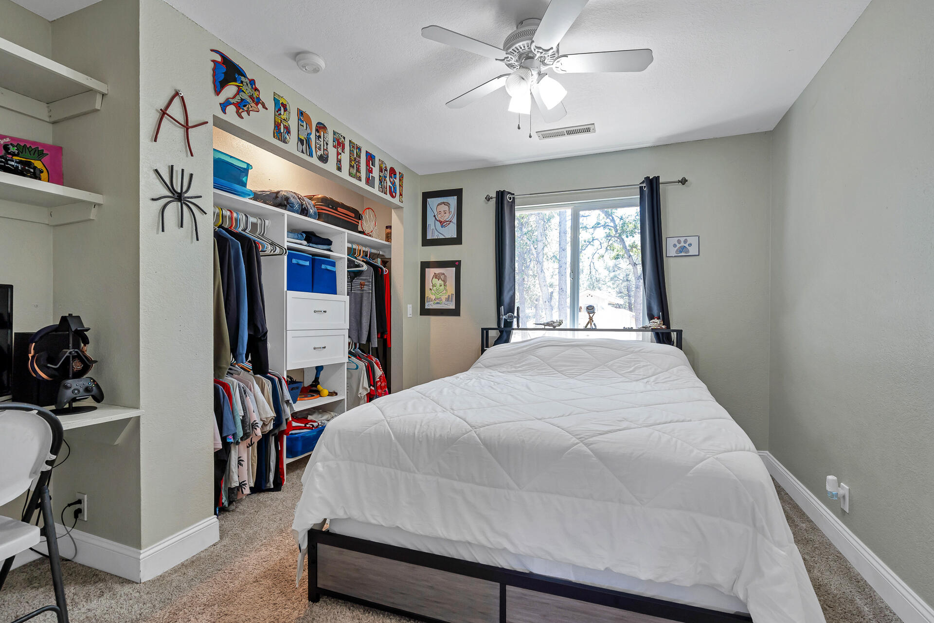 23570 Cassel Fall River Road Fall River Mills, CA 96028 - Photo 38 of 73 a bed room with a bed and a chandelier