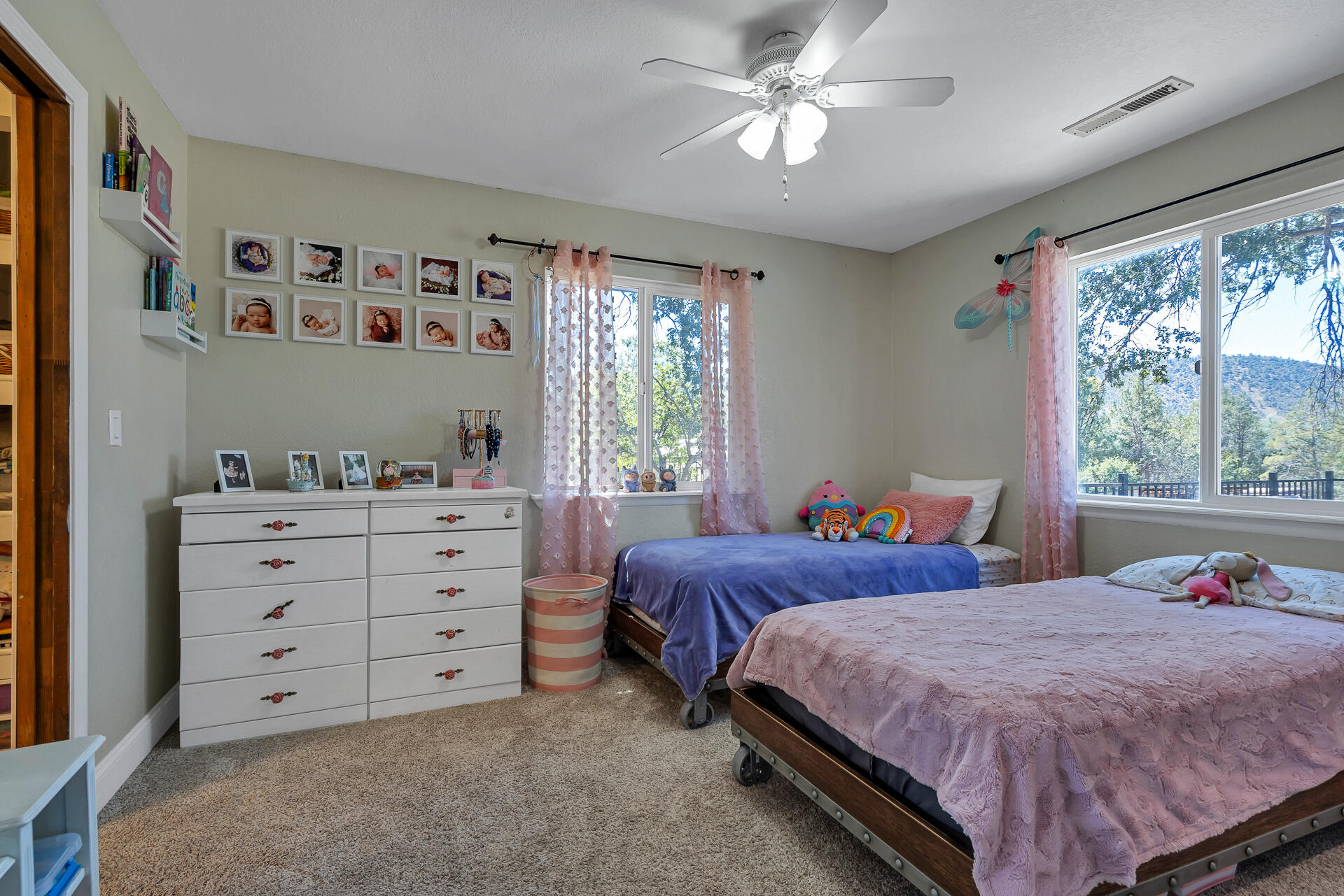 23570 Cassel Fall River Road Fall River Mills, CA 96028 - Photo 42 of 73 a bedroom with two beds and a window