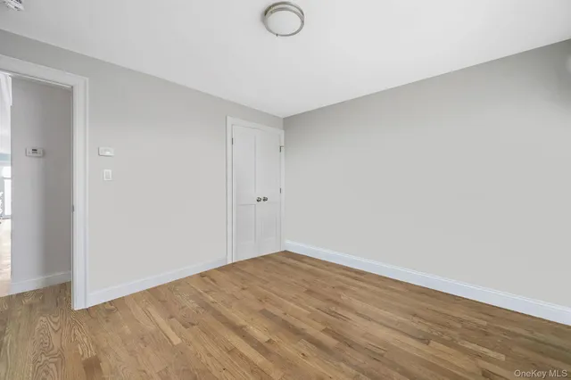 a view of a livingroom with wooden floor and windows